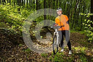 Cyclist Riding the Bike on a Trail in Summer Forest