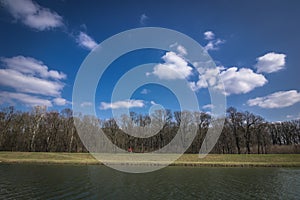 Cyclist riding on a cycle path beside the river