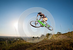 Cyclist riding downhill on mountain bike on the hill
