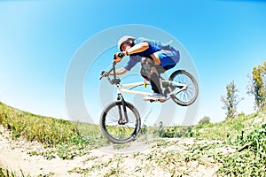 Cyclist riding jumping with bicycle cross-country