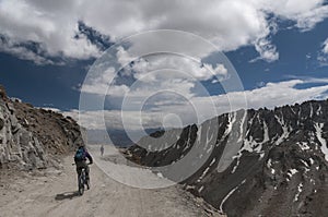 Cyclist riding in Khardungla Pass on Leh Nubra Road