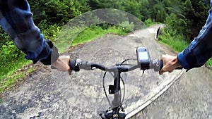 Cyclist riding mountain bike along dirt road with GPS in Bieszczady, Poland