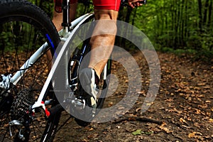 Cyclist riding mountain bike on rocky trail