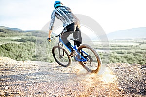 Cyclist riding on the rocky mountains