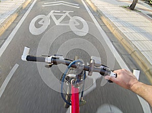 Cyclist riding y priority lane for bikes and electric kick scooters