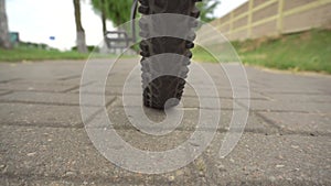 A cyclist rolls a bicycle with a flat, punctured wheel, close-up. Punched wheel tube, industry