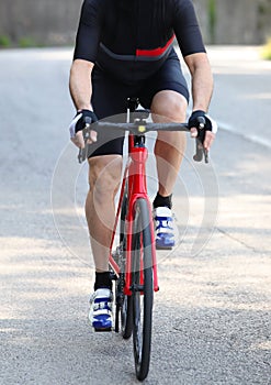 Cyclist with sportswear and shorts on a red racing bike pedaling