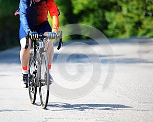 cyclist with sportswear while training pedaling on an asphalt ro