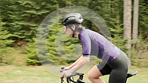 Cyclist sprinting out of saddle, hard training, taking part in bike race competition. Motivation. Triathlon. Fitness exercises. Ca