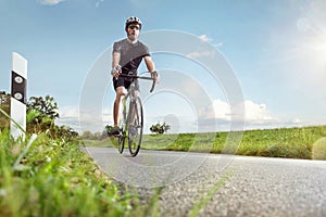 Cyclist on a sunny road