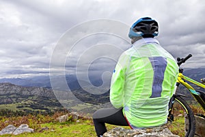 A cyclist takes a break to contemplate the landscape