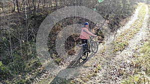 Cyclist Woman Riding On Bicycle On Countryside Road in autun forest, Having Fun And Enjoying Life. aerial shot