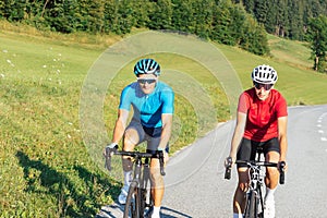 Cyclists couple on the road in summer cycling gear