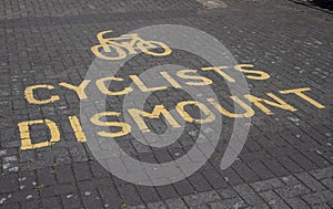 Cyclists dismount sign on the pavement Seacombe Wirral July 2020