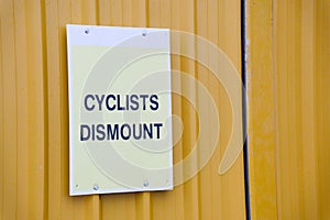 Cyclists dismount sign for safety of pedestrians on shared walk path