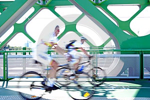 Cyclists in motion on a bridge