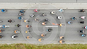 Cyclists pedal and compete along broad asphalt road