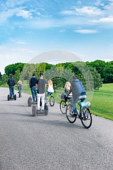 Cyclists ride along bike path in park