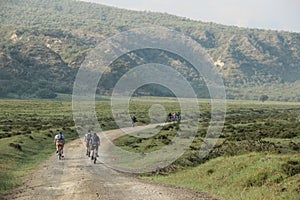 Cyclists ride bikes through Hell's Gate National Park in Kenya