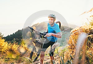 Cyclo-cross competition member Man mountain biker carrying his b