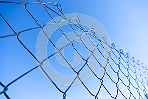 cyclone fence detail with blue sky