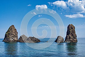 Cyclops island, basaltic rock fomation in Aci Trezza, Catania, Sicily, Italy. photo