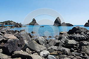 Cyclops islands, Acitrezza, Sicily. Basalt  rocks on the sea