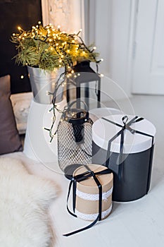 Cylinder gift boxes, cosy christmas decoration, flowers bucket on a background