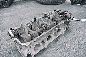 cylinder head lies on asphalt in yard of private house