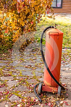 A cylinder of liquefied gas stands against