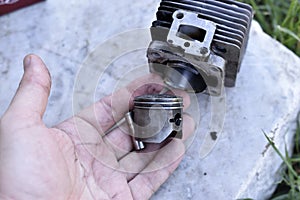 Cylinder and piston from internal combustion engine engine in hand