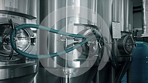 cylindrical conical fermentation tanks in workshop of beverage plant, stainless steel tun