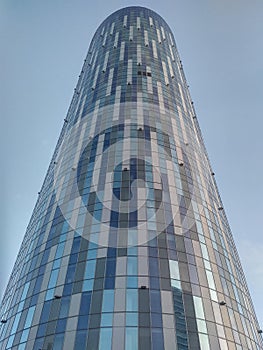 Cylindrical tower office building with mirror window effect