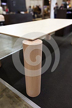 Cylindrical wooden coffee table leg with glass top