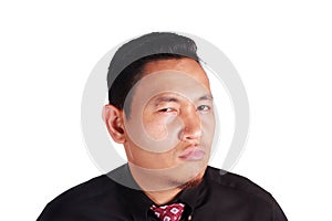 Cynical Asian businessman looking to camera with anger