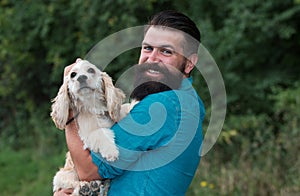 Cynologist concept. Man with Cocker Spaniel in dog park outdoors. Man with puppy.