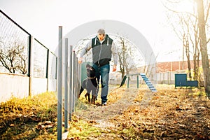 Cynologist with sniffing dog, training outside