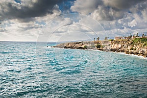 Cyprus coastline. Landscape of a Mediterranean rocky seashore before the storm below the stormy clouds