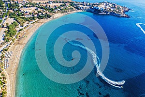 Cyprus landscape. Aerial panoramic view of Coral bay beach with jet ski and people having fun. Mediterranean vacation