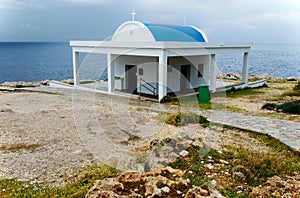 Cyprus, the Mediterranean coast. Church of Agia Anargiri on Cape Greco against the background of a summer storm sky photo