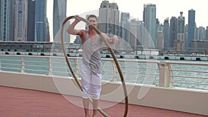 Cyr Wheel artist in slow motion with cityscape background of Dubai during sunrise