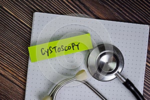 Cystoscopy write on sticky notes isolated on Wooden Table