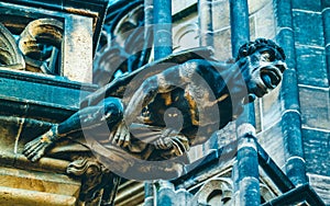 Czech architecture, scary gargoyle sculpture, gothic temple decoration. Medieval art, mystic gargoyle monster statue, St. Vitus C photo