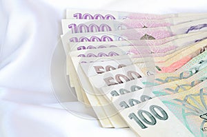 Czech banknotes money currency on white satin, silk fabric