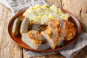 Czech food Dutch Schnitzel Holandsky Rizek served with mashed potatoes closeup on the plate. Horizontal