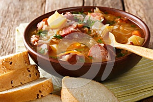 Czech food: Zelnacka cabbage soup with sausages and vegetables c photo