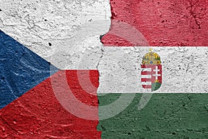 Czech Republic and Hungary - Cracked concrete wall painted with a Czech flag on the left and a Hungary flag on the right stock