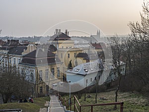 Czech Republic, Prague, February 23, 2021: View of Prague Karlov quarter and Vysehrad church from stairs at garden