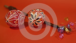 Czech rod with differently colored Easter eggs, red background