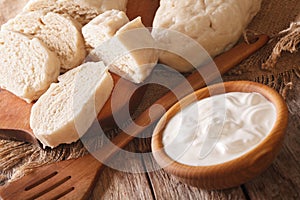 Czech sliced knedliks with sour cream close-up. horizontal